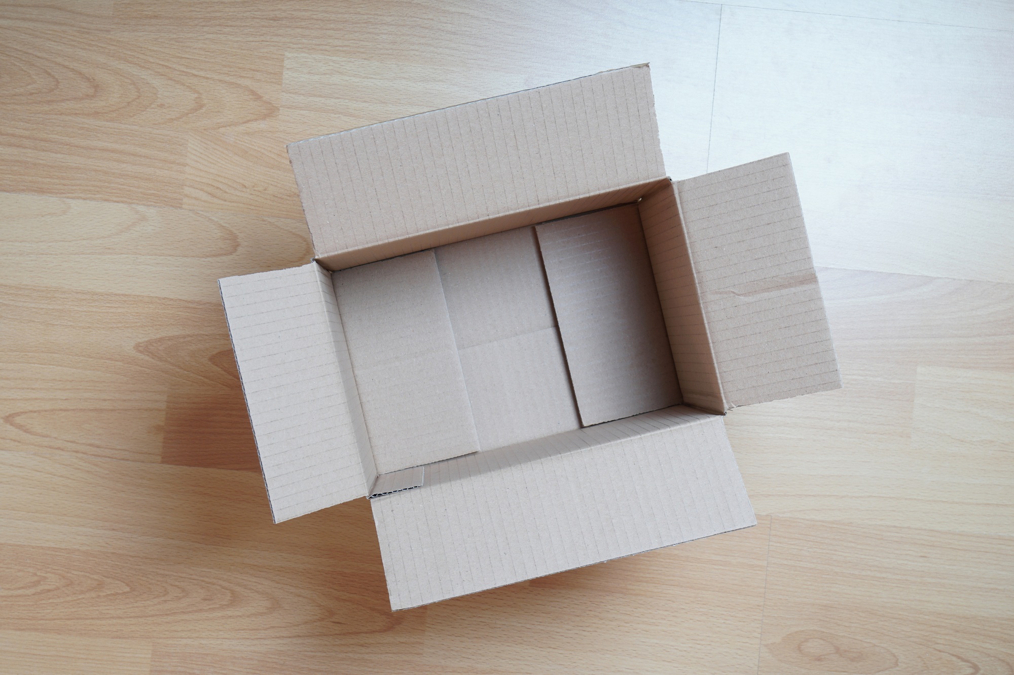 empty cardboard box on laminate floor